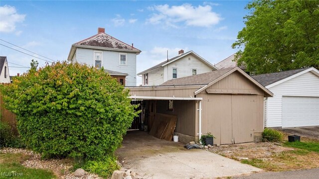 view of front of house with a garage and an outdoor structure