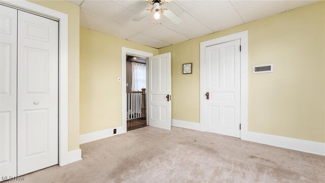 unfurnished bedroom featuring light colored carpet and ceiling fan