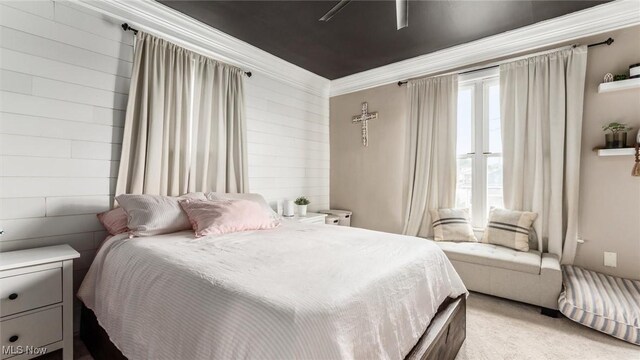 carpeted bedroom featuring crown molding and ceiling fan