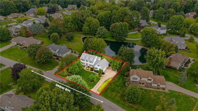 birds eye view of property with a water view