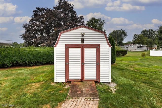 view of outdoor structure with a lawn