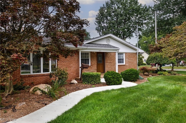 bungalow-style home featuring a front yard