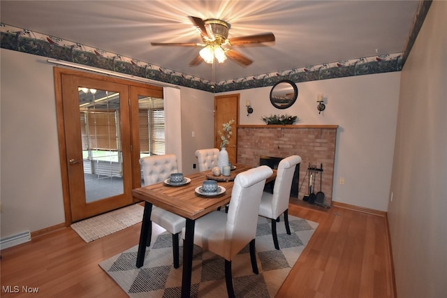 dining space featuring french doors, light hardwood / wood-style flooring, and ceiling fan