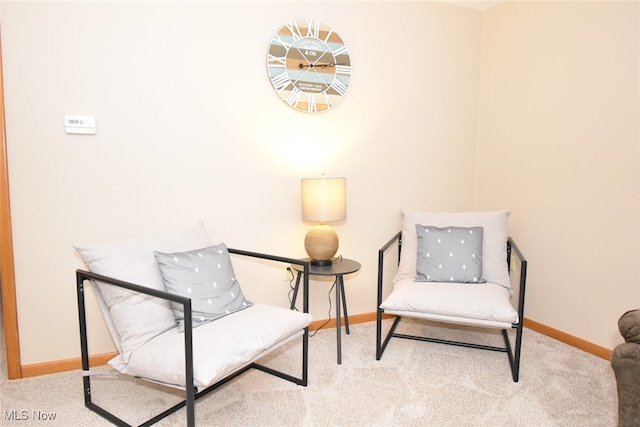 sitting room featuring light colored carpet