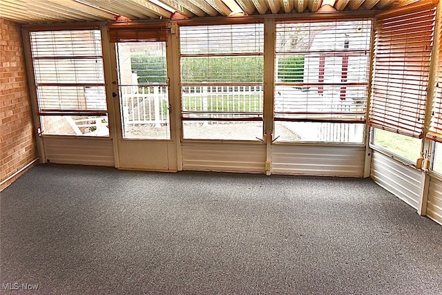 unfurnished sunroom with wooden ceiling