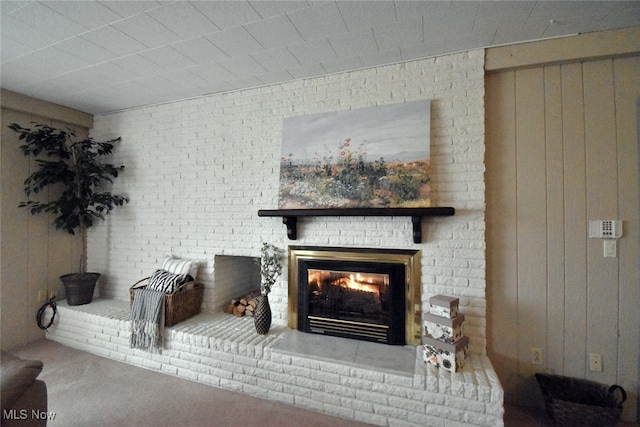 details featuring a fireplace, carpet, and wood walls