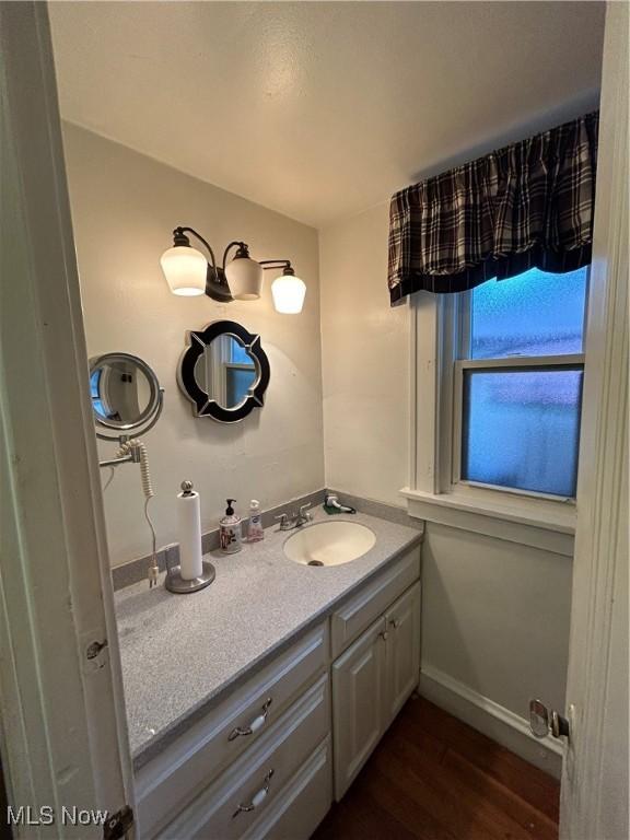 bathroom with vanity and hardwood / wood-style flooring