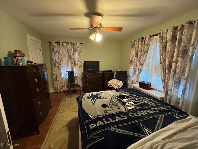 bedroom with ceiling fan and wood-type flooring