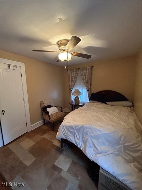 bedroom with baseboards, a ceiling fan, and tile patterned floors