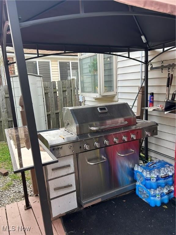 view of patio / terrace featuring a carport, grilling area, and a gazebo