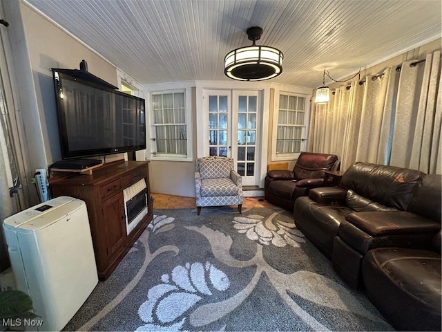 interior space with carpet floors, french doors, wood ceiling, and heating unit