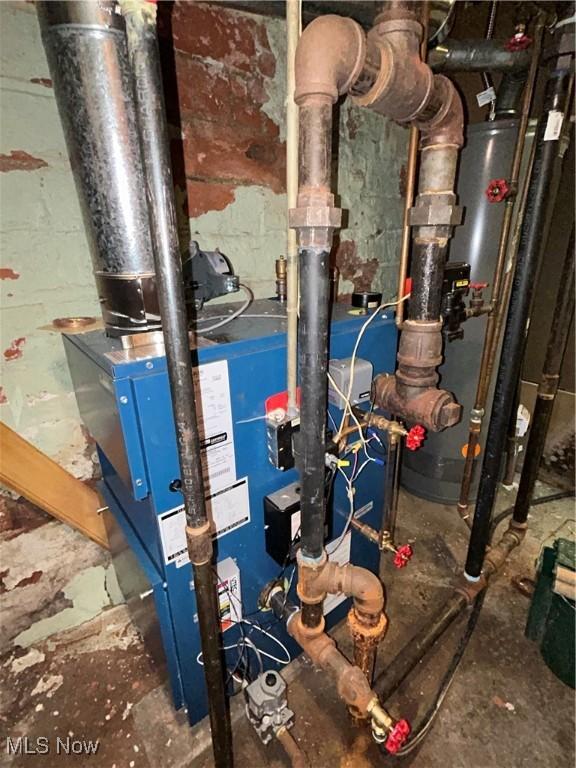 utility room featuring gas water heater