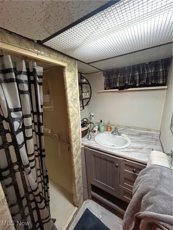 bathroom with vanity and a shower with shower curtain