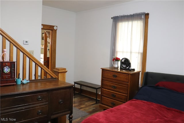 bedroom featuring dark hardwood / wood-style flooring and ornamental molding