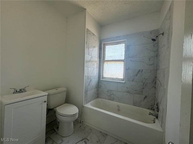 full bathroom with tiled shower / bath, toilet, sink, and a textured ceiling