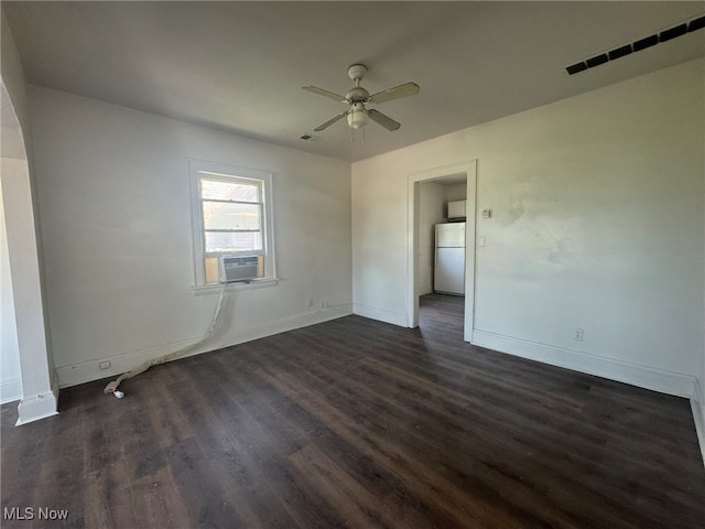 empty room with dark wood-type flooring, ceiling fan, and cooling unit