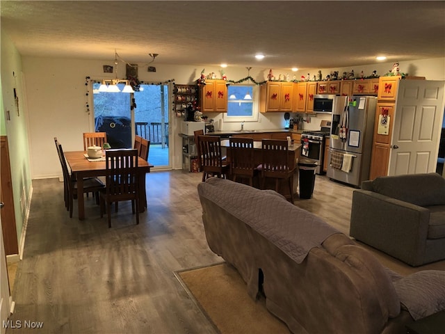 living room featuring light wood-type flooring, a textured ceiling, and sink