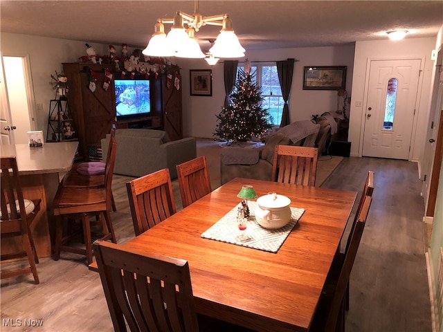 dining space with a chandelier and hardwood / wood-style flooring