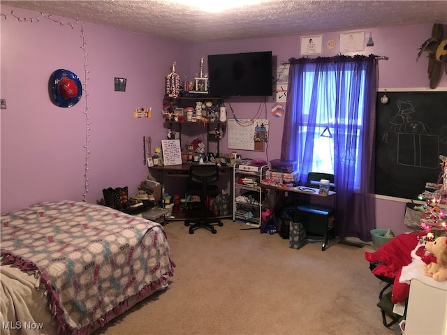 bedroom with a textured ceiling and carpet floors