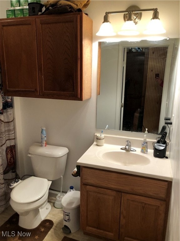 bathroom with toilet and vanity