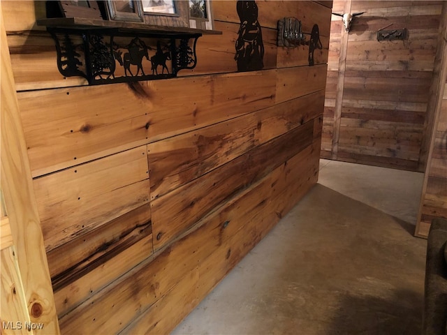 interior details featuring wood walls and concrete floors