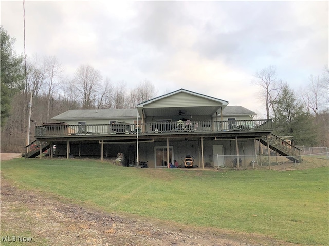 rear view of property with a lawn and a deck