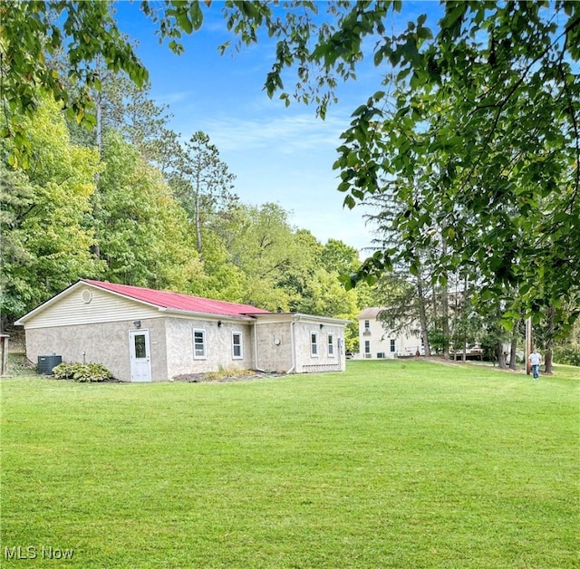 back of property featuring a yard and cooling unit