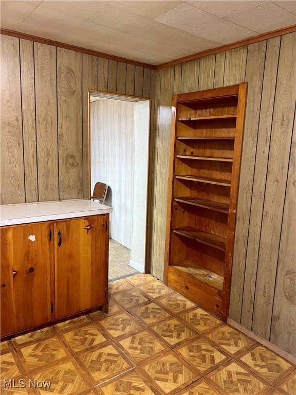 kitchen with light parquet floors and wooden walls