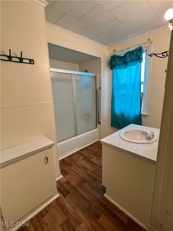 bathroom with vanity, an enclosed shower, and hardwood / wood-style flooring