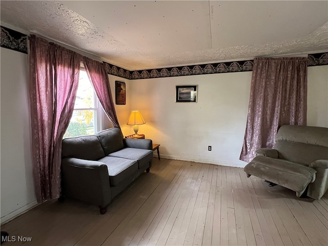 sitting room featuring a textured ceiling and hardwood / wood-style flooring