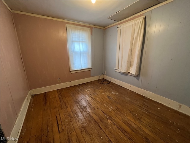 unfurnished room featuring ornamental molding and dark hardwood / wood-style floors