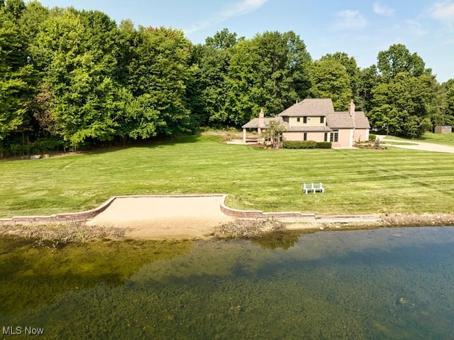 exterior space featuring a water view and a lawn