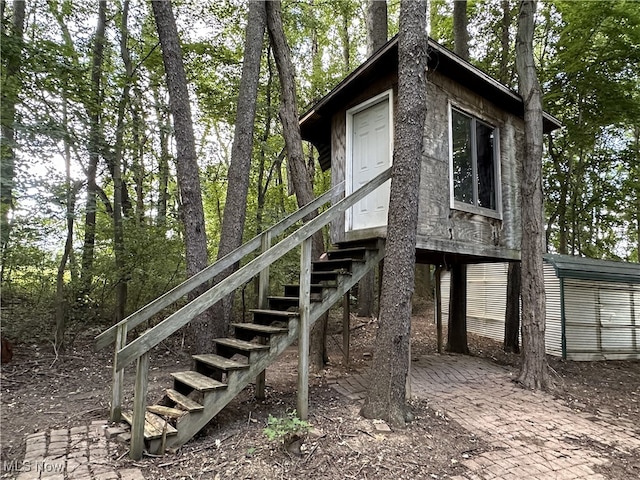 view of side of property with stairs