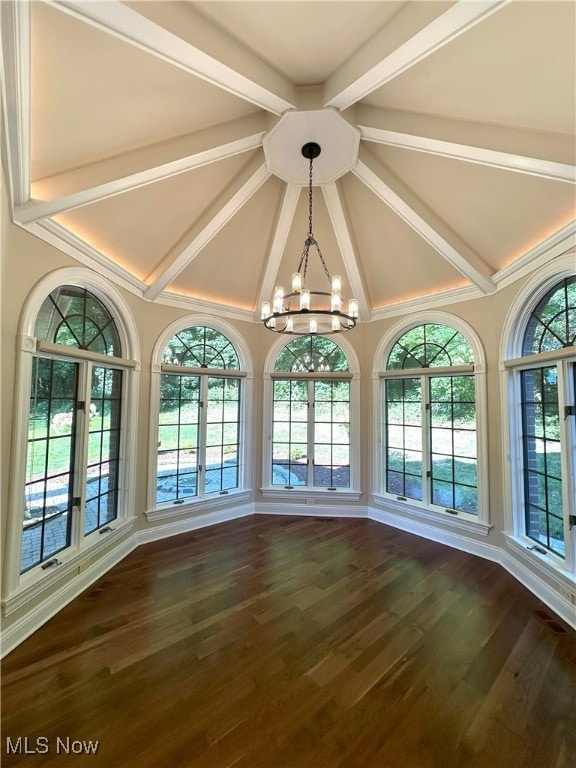 interior space with lofted ceiling with beams, dark wood-style flooring, and an inviting chandelier