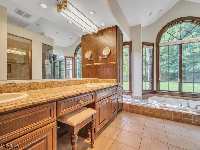 bathroom with lofted ceiling, visible vents, a sink, and a shower stall