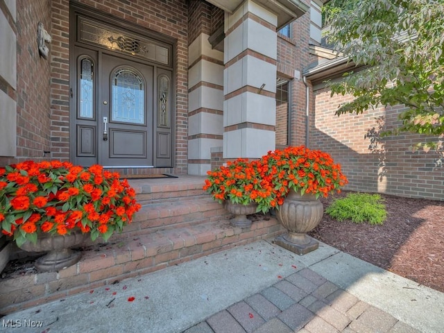 property entrance with brick siding