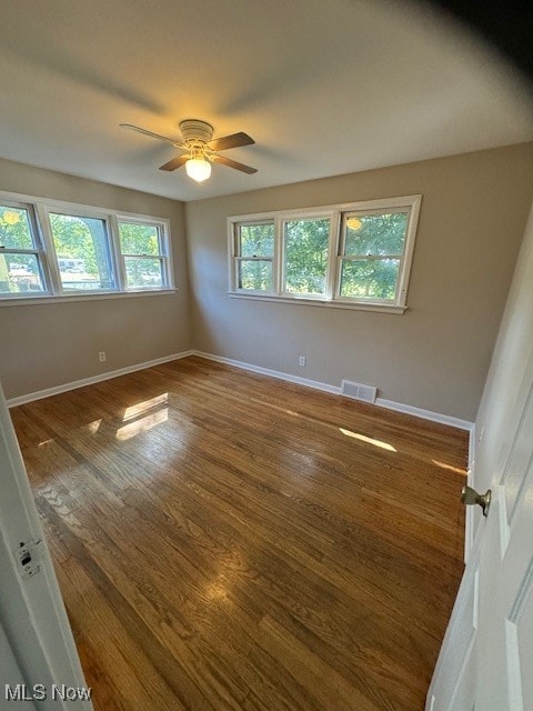 unfurnished room with ceiling fan and hardwood / wood-style floors