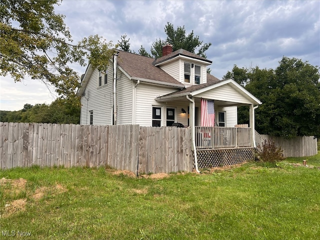 back of property featuring a yard