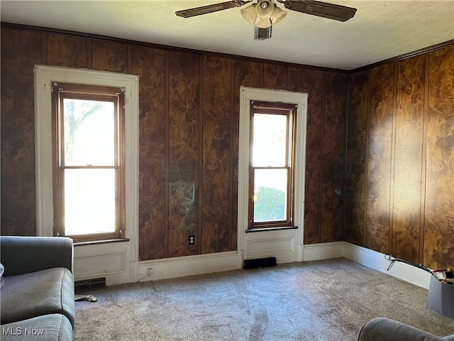 unfurnished room with carpet floors, a wealth of natural light, ceiling fan, and a textured ceiling