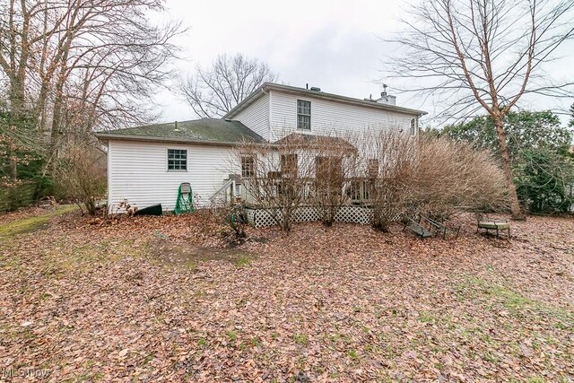 back of property featuring a wooden deck