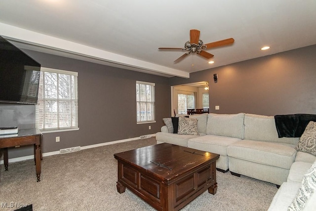 living room featuring light colored carpet and ceiling fan