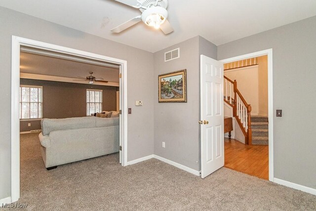 interior space featuring ceiling fan and carpet floors