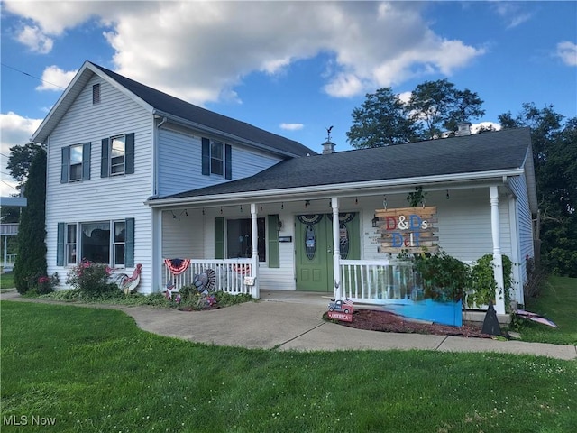 traditional home featuring covered porch and a front lawn