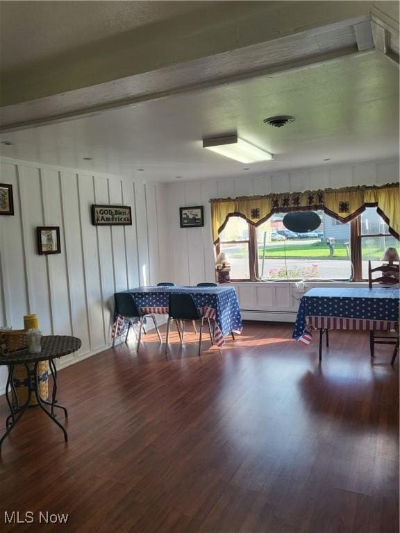 recreation room with a decorative wall, wood finished floors, and visible vents