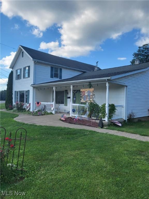 view of front of house with a porch and a front lawn