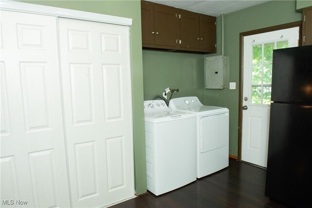 clothes washing area featuring cabinets, electric panel, dark hardwood / wood-style flooring, and washer and clothes dryer