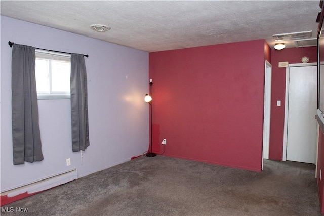 empty room with a textured ceiling, carpet floors, baseboard heating, and visible vents