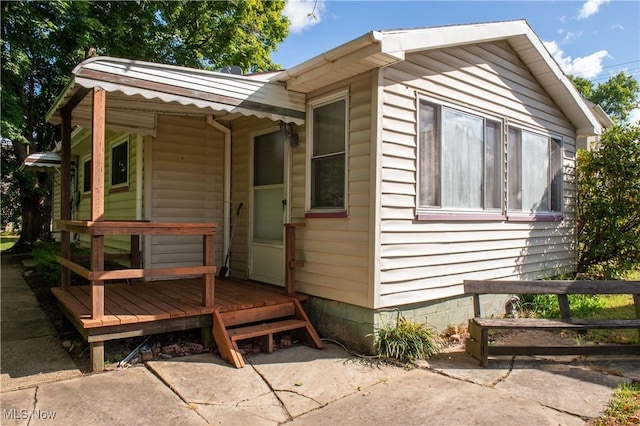 view of property exterior featuring a wooden deck