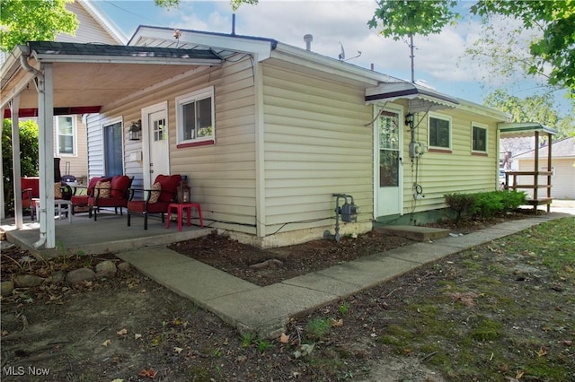 back of property with covered porch