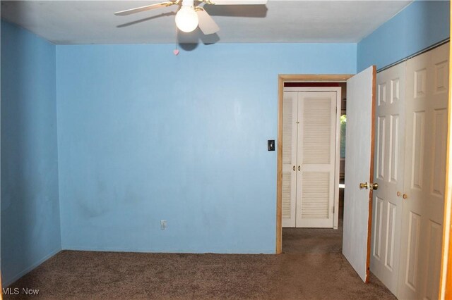 carpeted spare room featuring ceiling fan